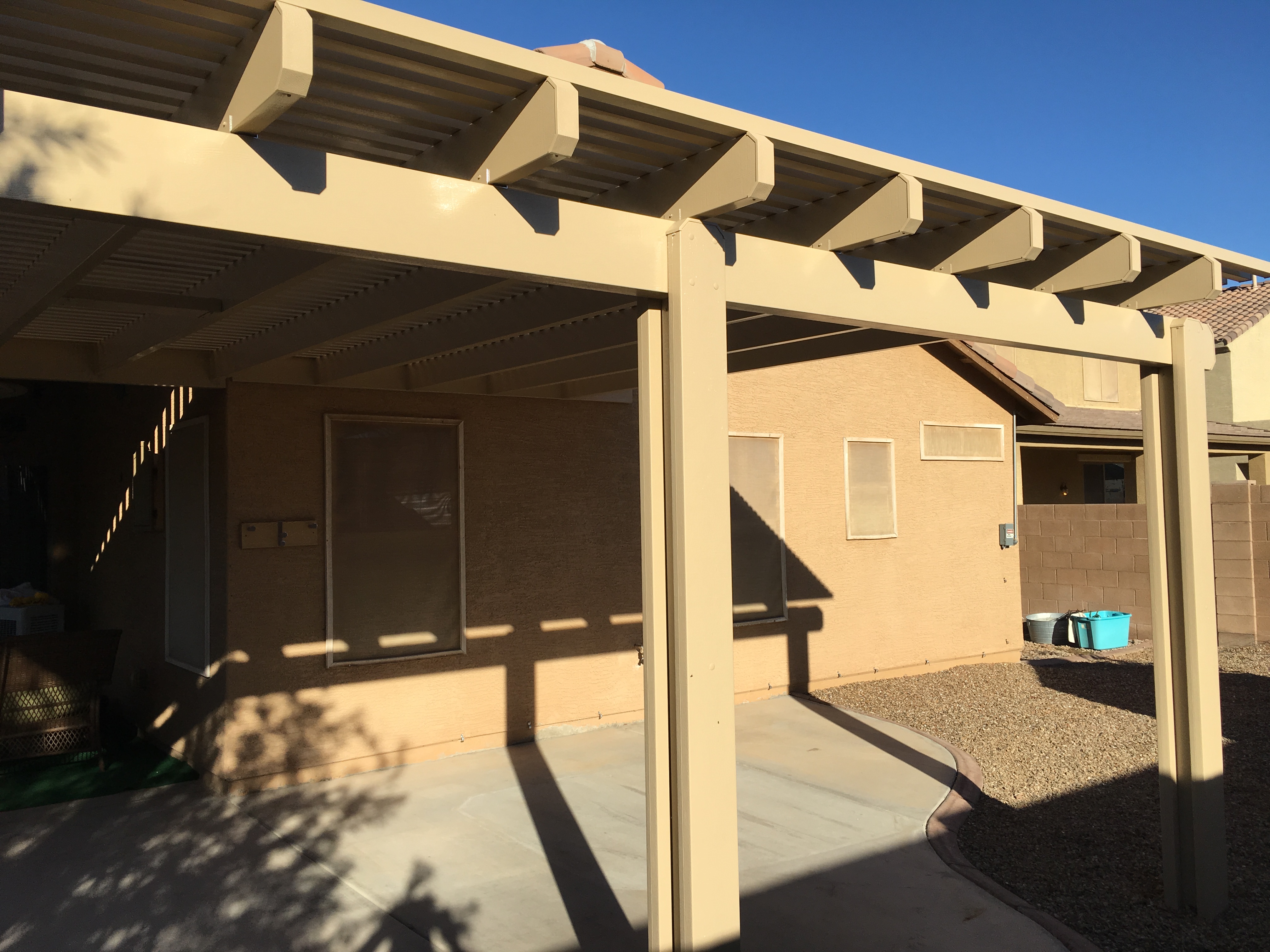 Modern Alumawood patio cover with insulated panels and motorized louver system.