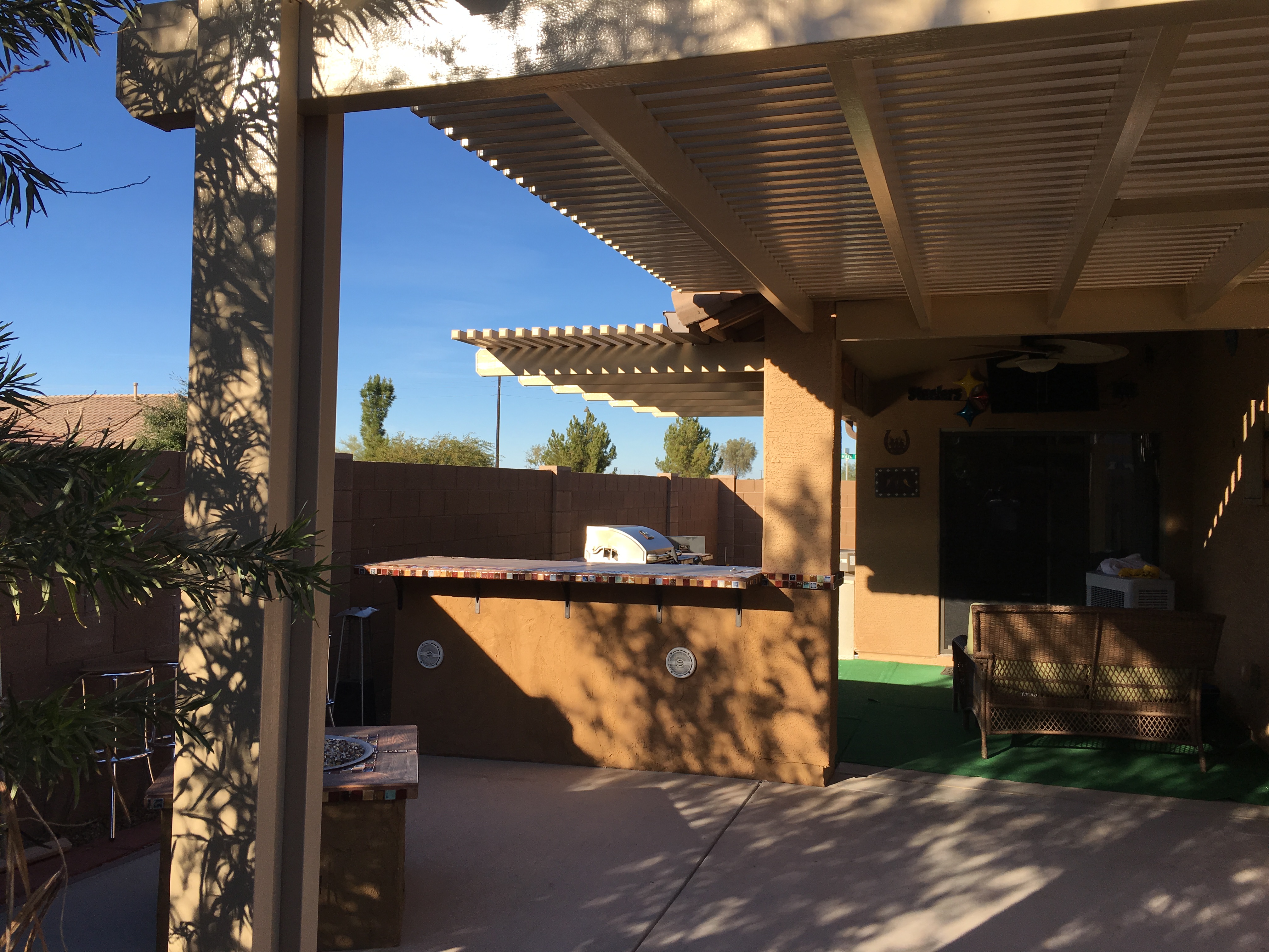 Modern Alumawood patio cover with insulated panels and motorized louver system.