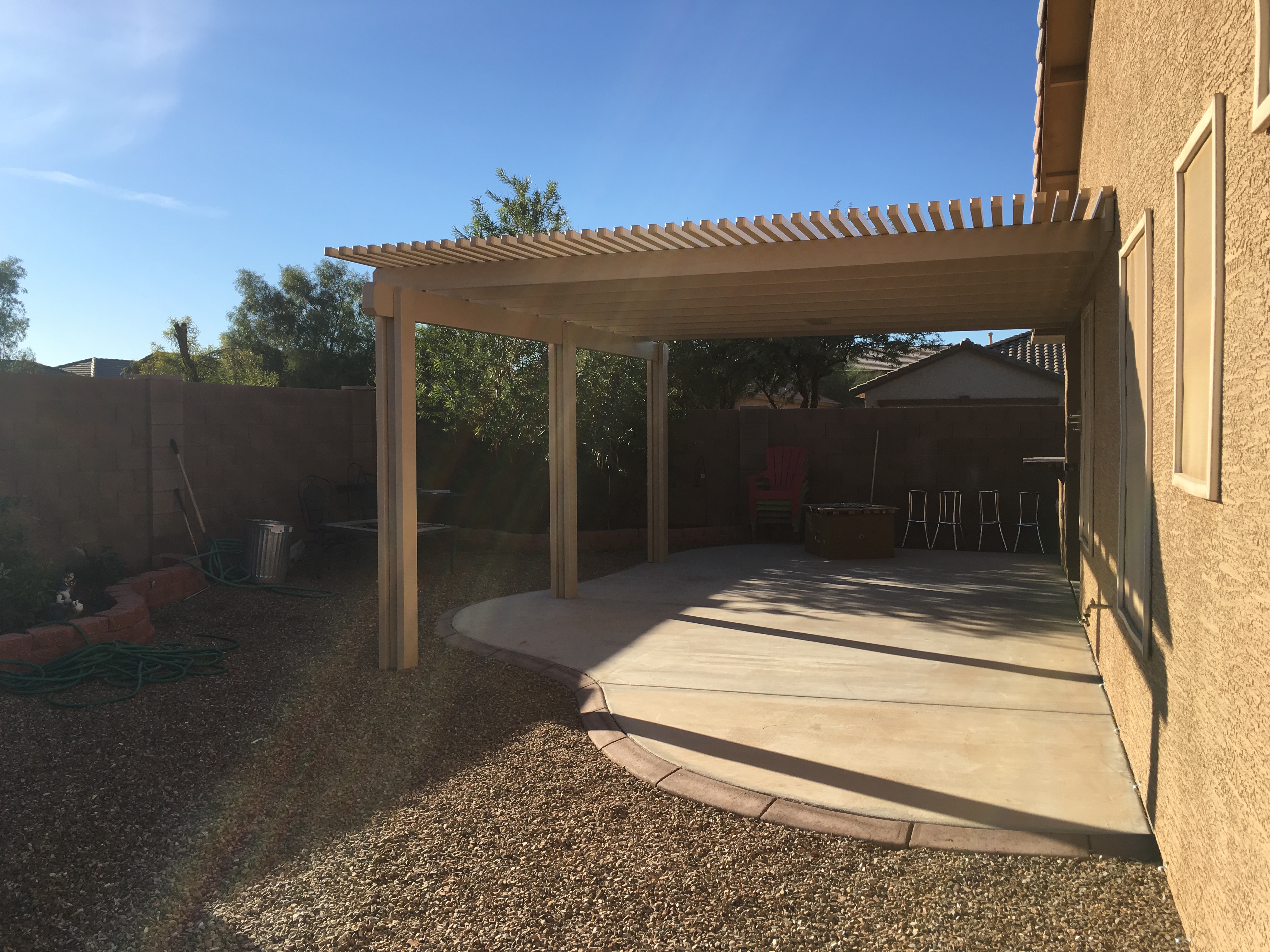 Modern Alumawood patio cover with insulated panels and motorized louver system.