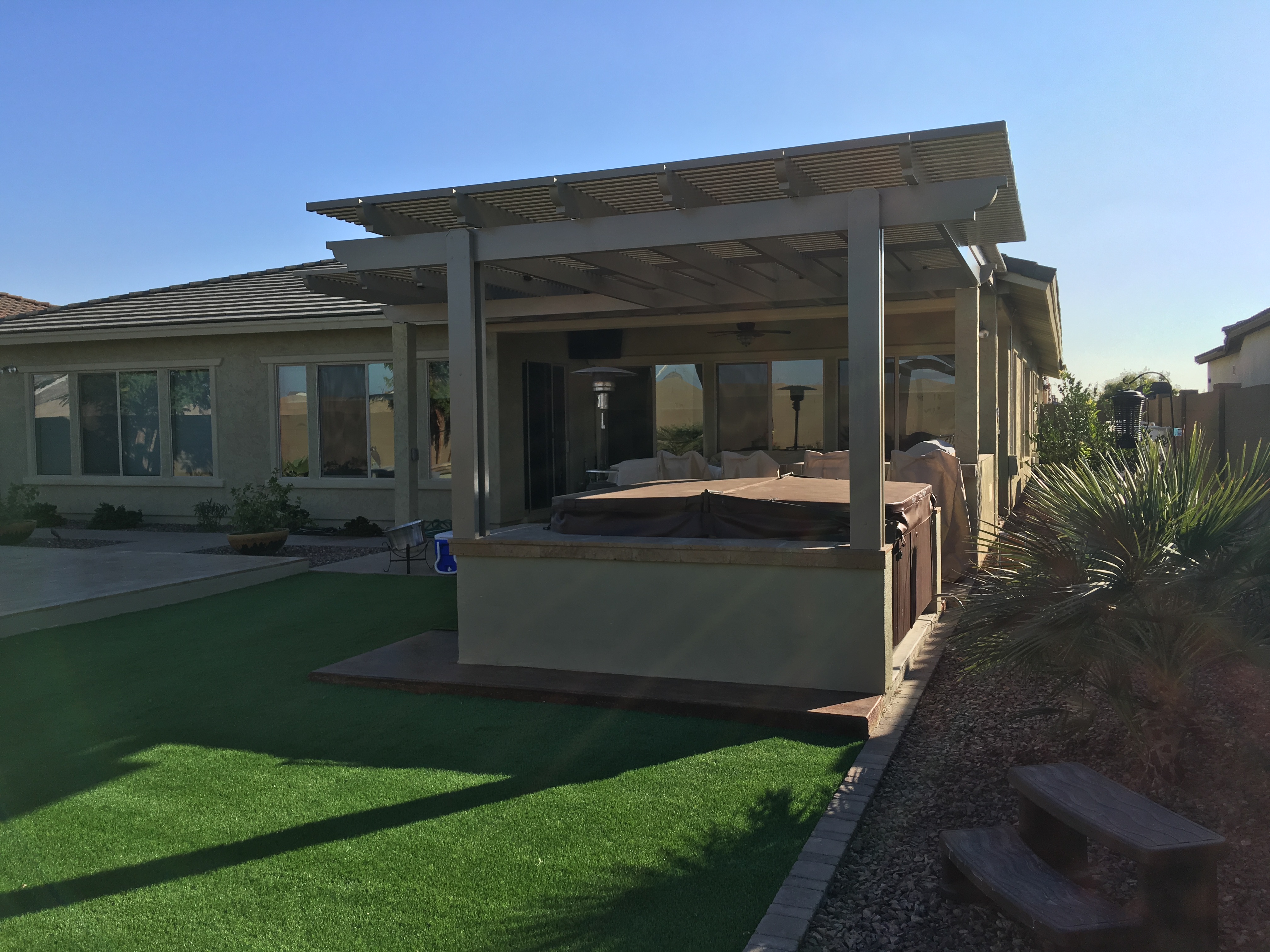 Modern Alumawood patio cover with insulated panels and motorized louver system.