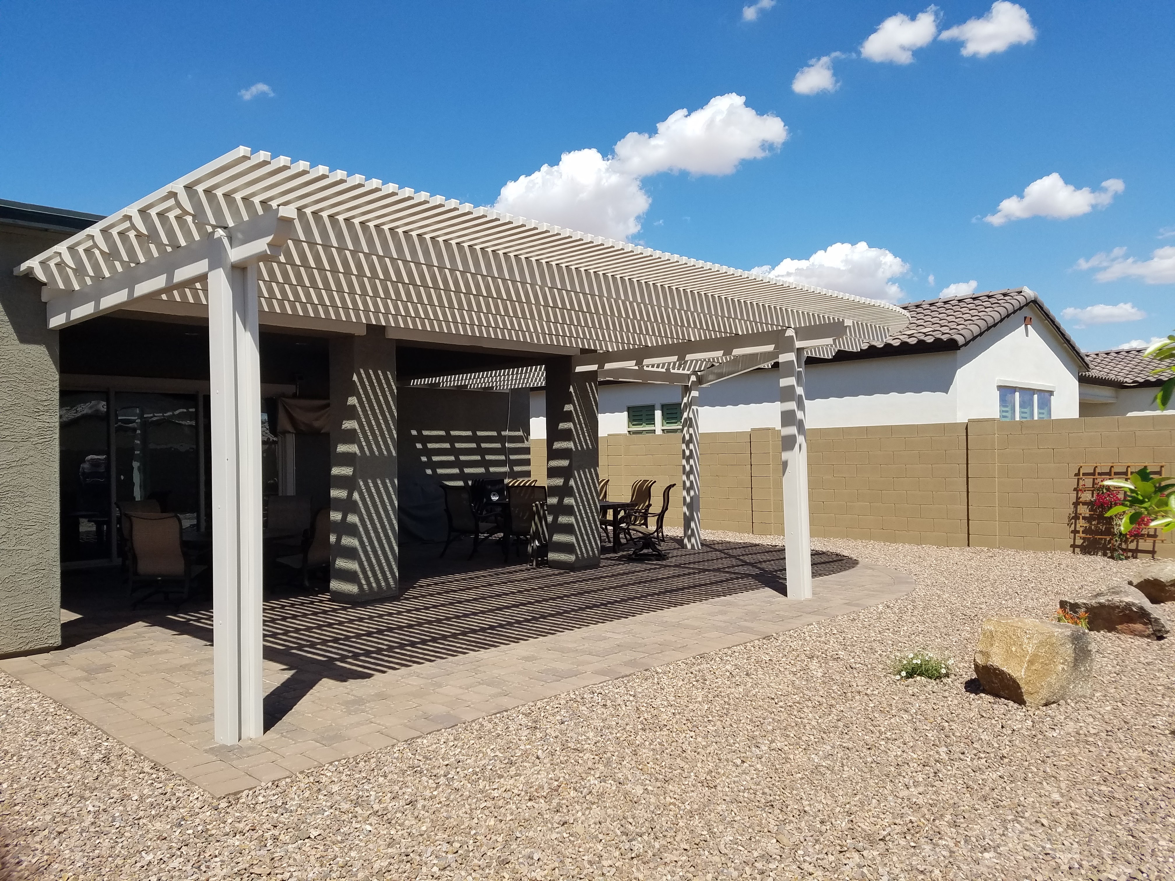 Modern Alumawood patio cover with insulated panels and motorized louver system.
