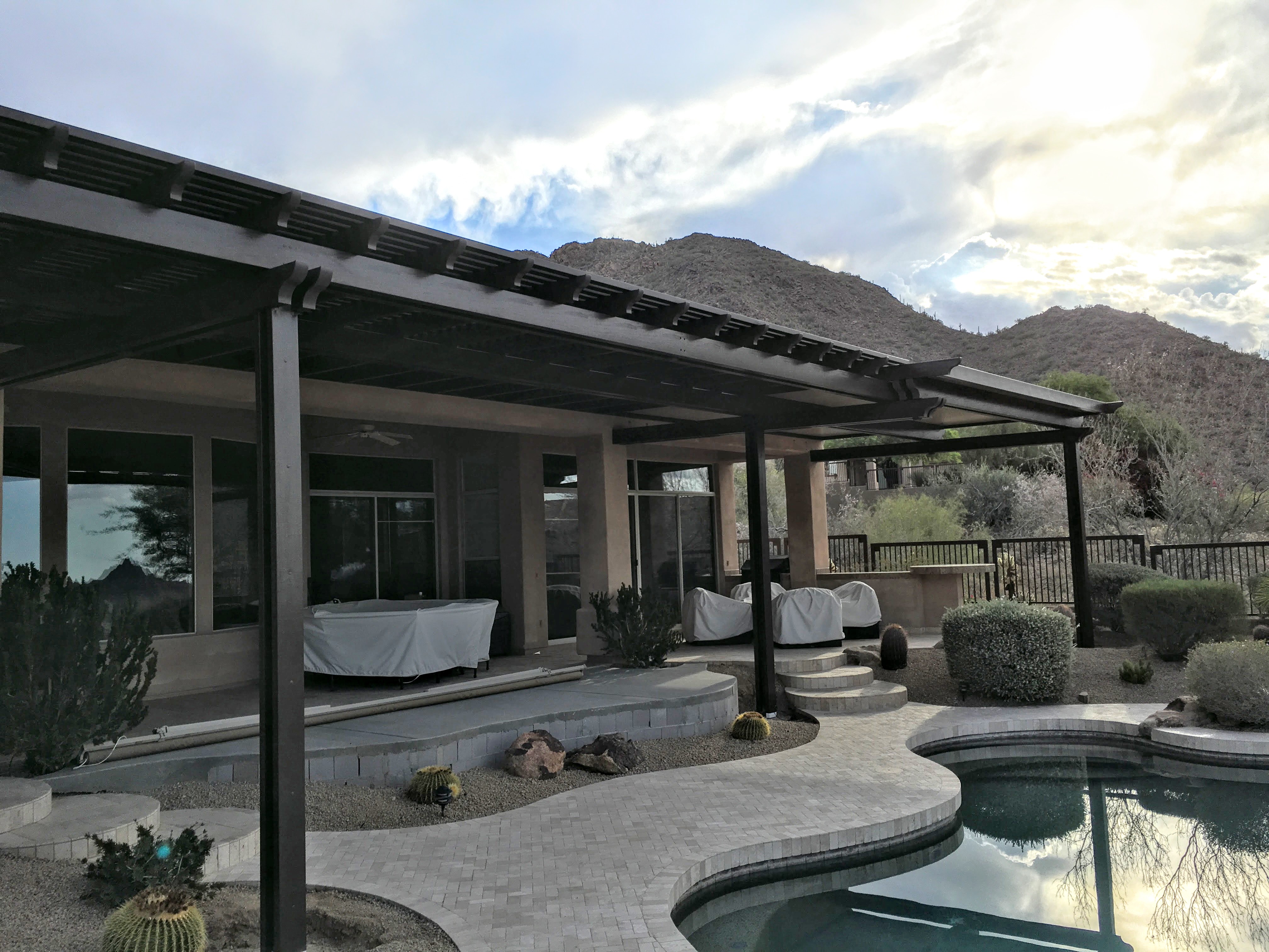 Modern Alumawood patio cover with insulated panels and motorized louver system.