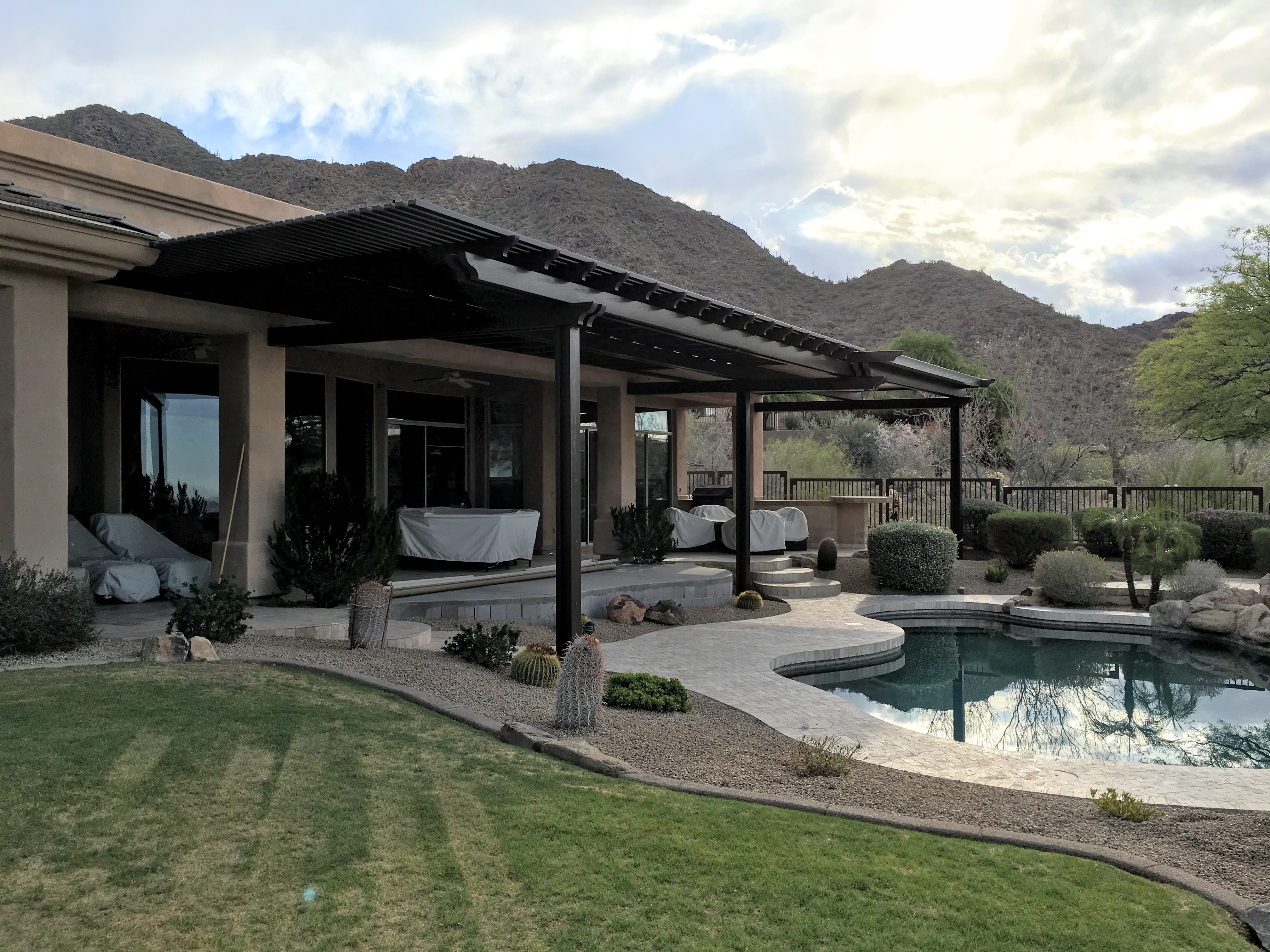 Modern Alumawood patio cover with insulated panels and motorized louver system.