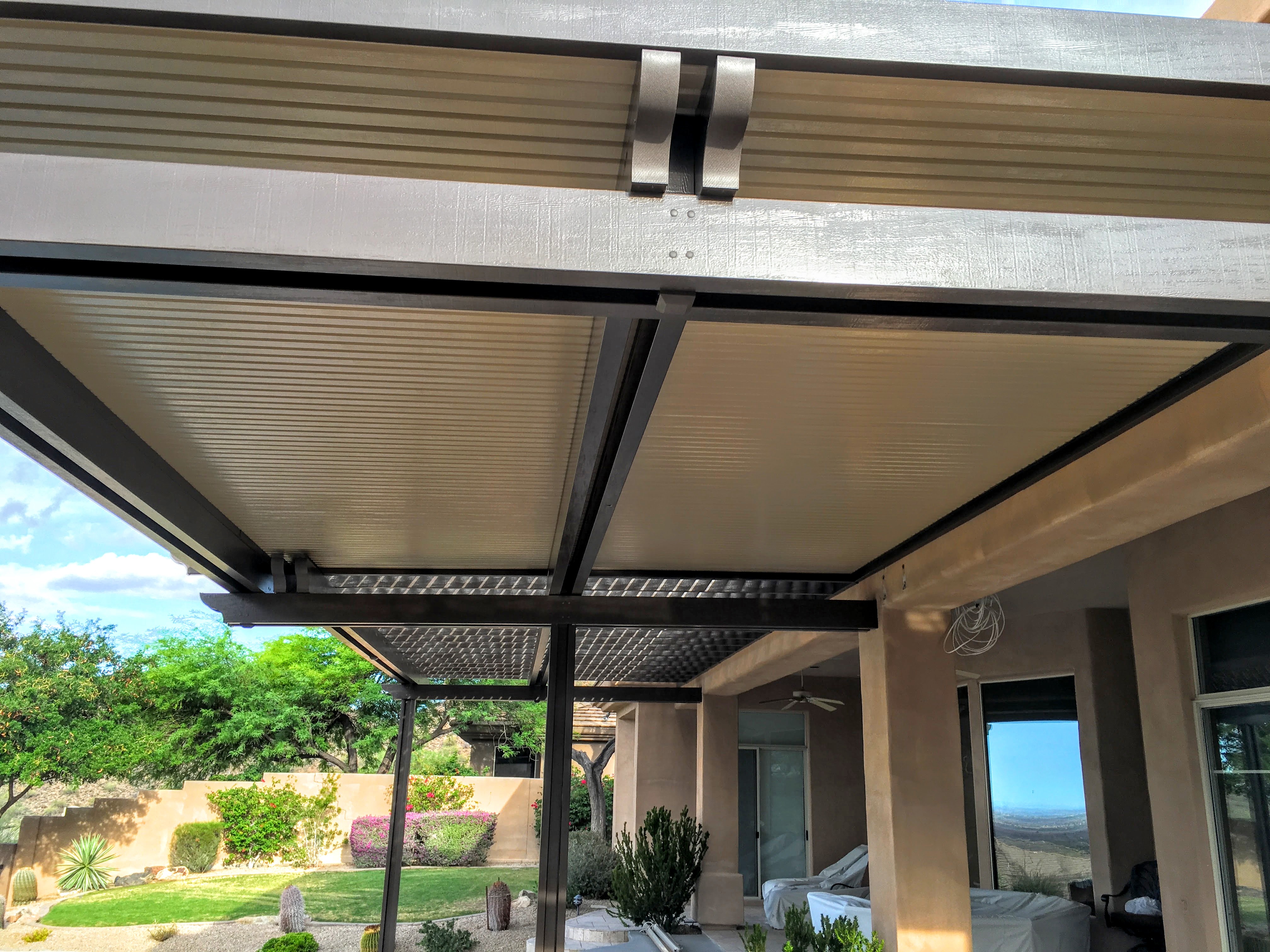 Modern Alumawood patio cover with insulated panels and motorized louver system.