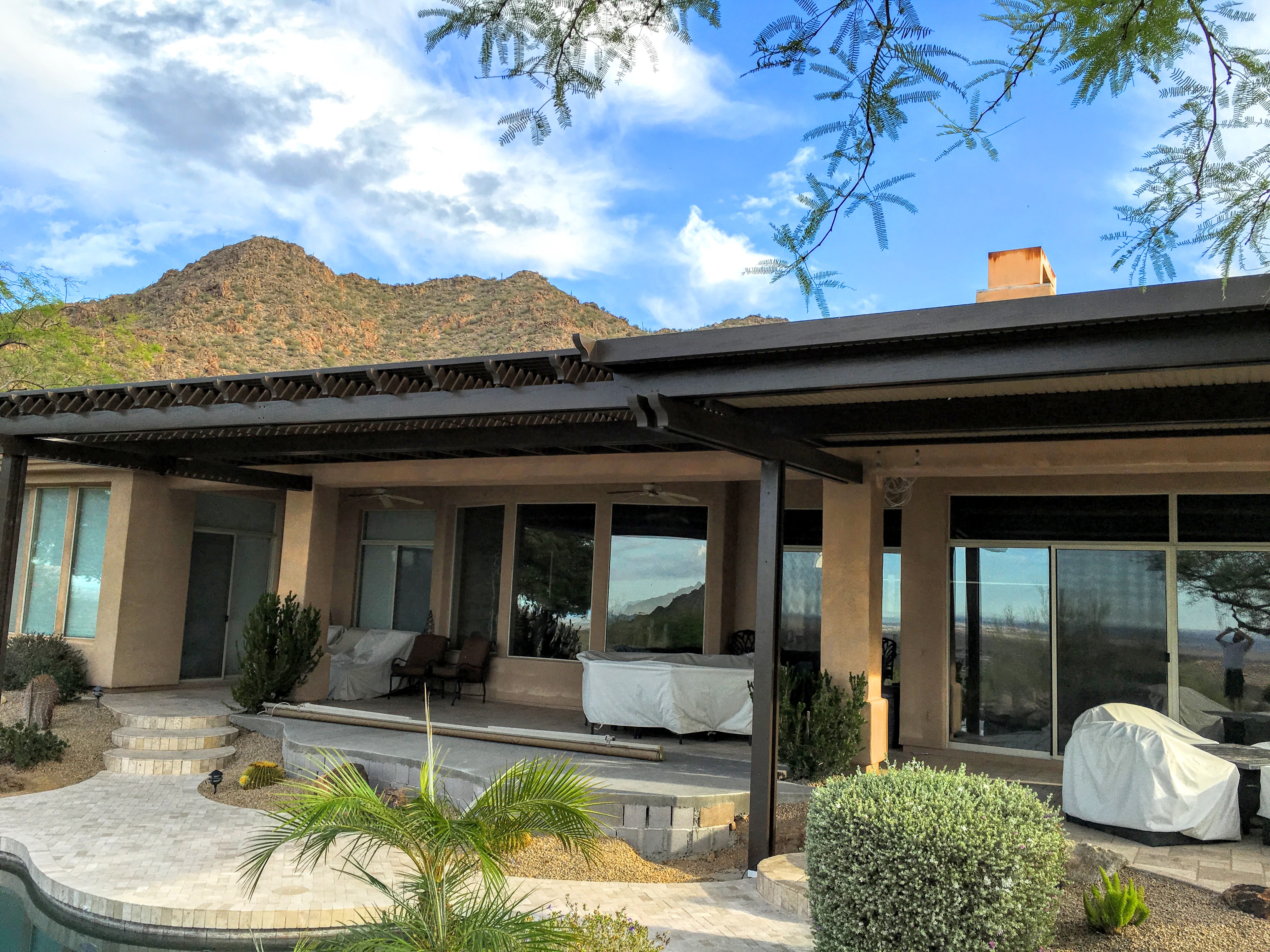 Modern Alumawood patio cover with insulated panels and motorized louver system.