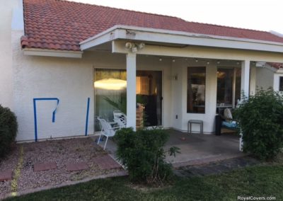 A photograph of a solid Alumawood patio cover installation over a residential backyard, highlighting the complete sun protection and covered outdoor living area it provides.