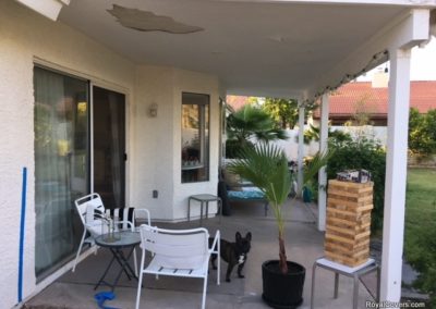 A photograph of a solid Alumawood patio cover installation over a residential backyard, highlighting the complete sun protection and covered outdoor living area it provides.