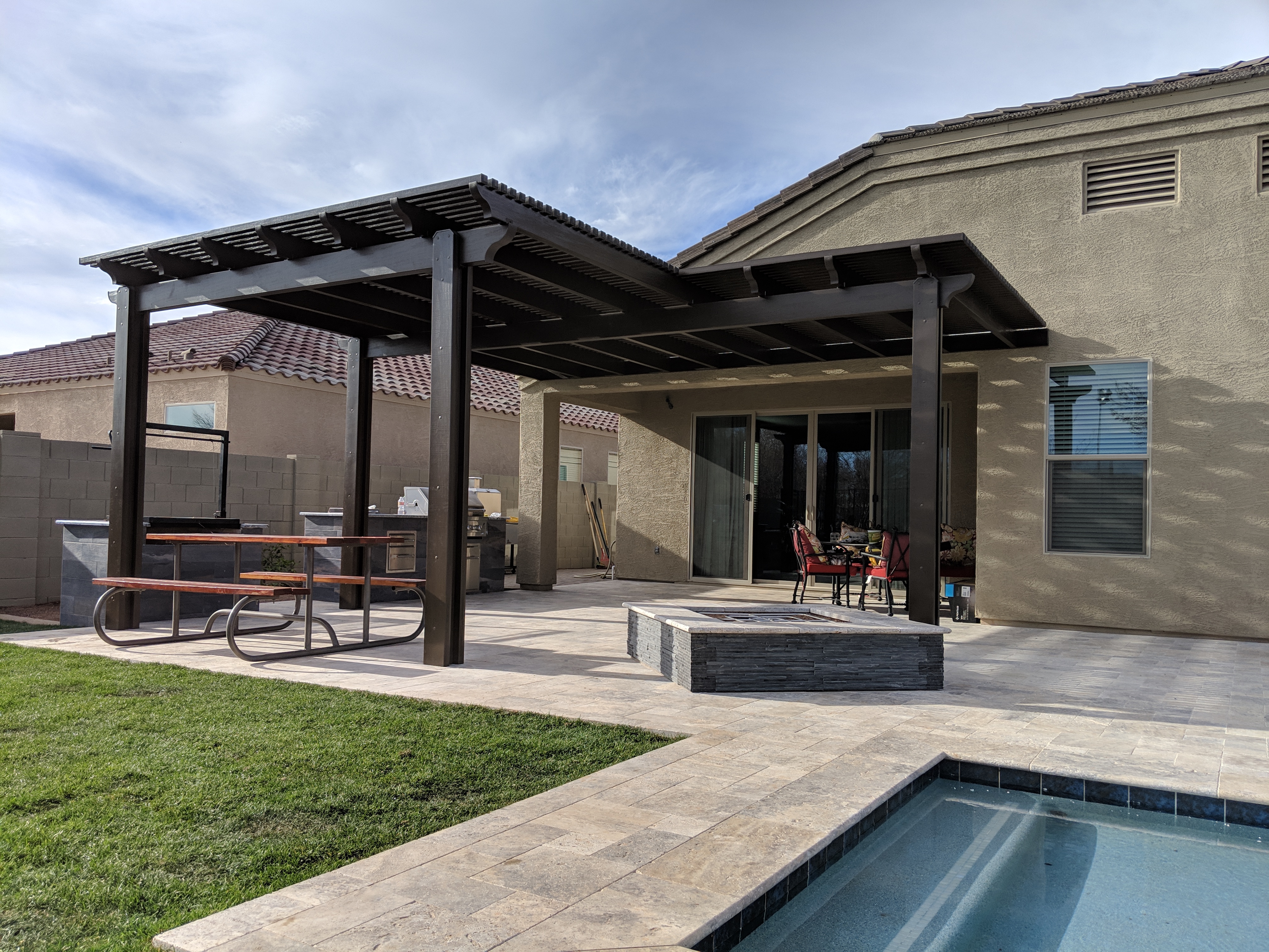 Modern Alumawood patio cover with insulated panels and motorized louver system.
