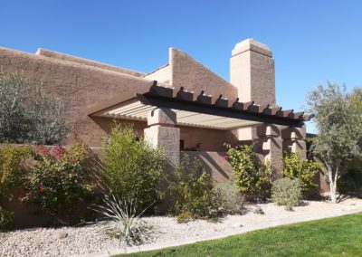 A photograph showcasing an Equinox louvered roof system installed over a residential patio, highlighting the adjustable slats that allow for customizable light and ventilation control in an outdoor living space.