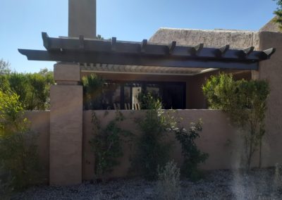 A photograph showcasing an Equinox louvered roof system installed over a residential patio, highlighting the adjustable slats that allow for customizable light and ventilation control in an outdoor living space.