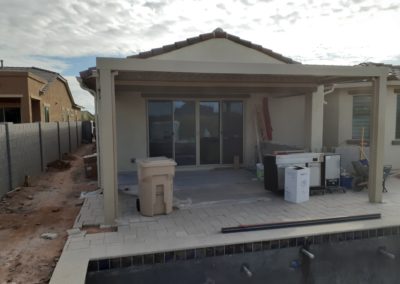 A photograph showcasing an Equinox louvered roof system installed over a residential patio, highlighting the adjustable slats that allow for customizable light and ventilation control in an outdoor living space.