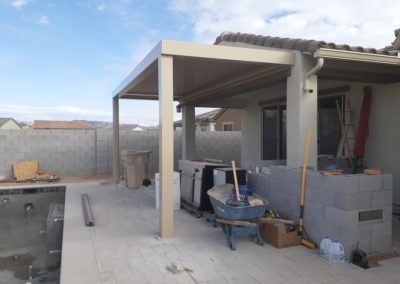 A photograph showcasing an Equinox louvered roof system installed over a residential patio, highlighting the adjustable slats that allow for customizable light and ventilation control in an outdoor living space.