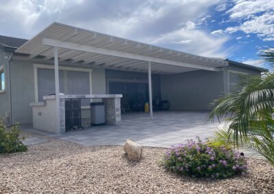 A photograph showing a completed patio cover installation, highlighting its design and the functional shade it provides to a residential backyard area.