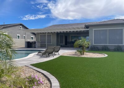 A photograph showing a completed patio cover installation, highlighting its design and the functional shade it provides to a residential backyard area.