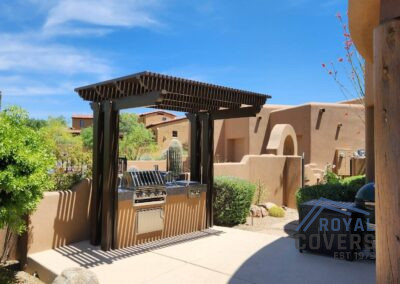 A photograph capturing a finished Alumawood patio cover installation in a residential backyard, highlighting the structure's design and the shade it creates for the outdoor living area.